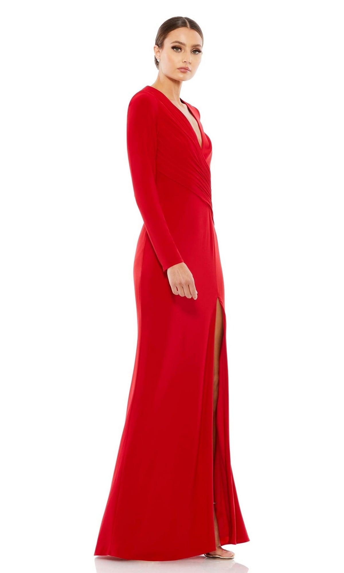 A woman wears the Mac Duggal 26686 long sleeve formal dress—a floor-length red v-neck gown with a high slit—standing against a white background.